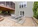 Cozy patio with outdoor seating and a view of the house's upper deck at 2710 Providence Spring Ln, Charlotte, NC 28270