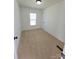 This bedroom has carpet, a window with blinds, and a door at 2822 Hugh Rd, Shelby, NC 28150