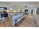 Modern kitchen featuring white cabinets, stainless steel appliances, island with barstool seating, and open floor plan at 2822 Hugh Rd, Shelby, NC 28150