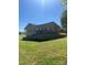 Exterior view with brick finishes, surrounded by an extensive grassy yard at 28344 Canton Rd, Albemarle, NC 28001