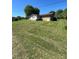 Vast backyard with well-manicured grass surrounding a home addition and several sheds at 28344 Canton Rd, Albemarle, NC 28001