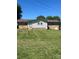 Backyard of home featuring an addition to the main structure with a lush, green lawn at 28344 Canton Rd, Albemarle, NC 28001