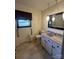 Bathroom with granite vanity, decorative mirror, handicap bar, and tiled floors at 28344 Canton Rd, Albemarle, NC 28001