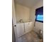 Bathroom featuring walk-in tub with grab bars, blue shade, toilet, and beige tile floor at 28344 Canton Rd, Albemarle, NC 28001