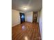 Bright bedroom featuring hardwood floors, neutral walls and a window with elegant curtains at 28344 Canton Rd, Albemarle, NC 28001