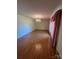 The spacious living room is adorned with hardwood floors, a decorative chandelier and light-colored walls at 28344 Canton Rd, Albemarle, NC 28001