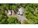 Aerial view of a house with metal roof and long driveway surrounded by lush green trees at 29268 Pennington Rd, Albemarle, NC 28001