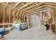 Unfinished attic space with exposed rafters, a bed frame, and a bathroom at 29268 Pennington Rd, Albemarle, NC 28001