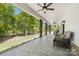 Expansive back porch with comfortable seating, ceiling fans, and serene views of the surrounding greenery at 29268 Pennington Rd, Albemarle, NC 28001