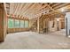Unfinished basement space with exposed wood framing, and three bright windows at 29268 Pennington Rd, Albemarle, NC 28001