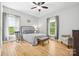 Cozy bedroom featuring hardwood floors, bright windows with curtains, and soft, natural light at 29268 Pennington Rd, Albemarle, NC 28001
