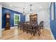 Elegant dining room with hardwood floors, stylish lighting, and beautiful blue accent wall and wallpaper at 29268 Pennington Rd, Albemarle, NC 28001