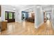 Spacious foyer with gleaming hardwood floors, leading to a dining room with blue accent wall and grand dining table at 29268 Pennington Rd, Albemarle, NC 28001
