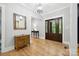 Welcoming foyer featuring hardwood floors, a stylish mirror, and an elegant front door with glass panels at 29268 Pennington Rd, Albemarle, NC 28001