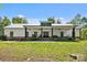 Charming farmhouse featuring a white exterior, metal roof, and inviting front porch with chairs and swing at 29268 Pennington Rd, Albemarle, NC 28001