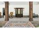 Inviting front porch with wood columns, rocking chairs, and decorative lighting flanking the front door at 29268 Pennington Rd, Albemarle, NC 28001