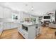 Open concept kitchen with center island, breakfast bar, and seamless flow to living room at 29268 Pennington Rd, Albemarle, NC 28001
