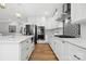 Updated kitchen with an island, stainless steel appliances, white cabinets, and gas range at 29268 Pennington Rd, Albemarle, NC 28001
