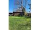 Spacious backyard with a wooden pergola-style structure, offering a versatile outdoor area surrounded by green grass at 3003 Eaker Dr, Cherryville, NC 28021