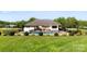 Expansive backyard featuring a pristine pool area, outdoor dining, and lush greenery for ultimate relaxation at 3003 Eaker Dr, Cherryville, NC 28021