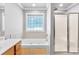 Bathroom with a soaking tub, glass block window, and walk-in shower at 3003 Eaker Dr, Cherryville, NC 28021