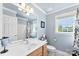 Light-filled bathroom featuring a large mirror, vanity, and bathtub with shower at 3003 Eaker Dr, Cherryville, NC 28021
