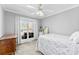 Neutral bedroom featuring a ceiling fan, plush carpet, and a large window at 3003 Eaker Dr, Cherryville, NC 28021