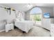 Upstairs bedroom with arched window, white walls, and display shelves at 3003 Eaker Dr, Cherryville, NC 28021