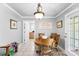 Cozy dining room with wood table, chandelier lighting, and access to outdoor patio at 3003 Eaker Dr, Cherryville, NC 28021