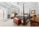 Spacious bedroom with a four-poster bed, tray ceiling, and neutral carpet at 3003 Eaker Dr, Cherryville, NC 28021
