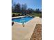 Beautiful in-ground pool with a stone water feature and plenty of patio space at 3003 Eaker Dr, Cherryville, NC 28021