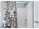 Clean white shower and black and white patterned shower curtain at 3003 Eaker Dr, Cherryville, NC 28021