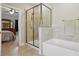 Well-lit bathroom with a walk-in shower and a relaxing soaking tub next to the walk-in shower at 3013 Isle Ln, Monroe, NC 28110