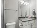 Bright bathroom featuring granite countertops, white cabinetry, and updated fixtures for a spa-like feel at 3013 Isle Ln, Monroe, NC 28110