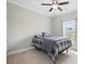 Carpeted bedroom with large window offers natural light and a ceiling fan for added comfort at 3013 Isle Ln, Monroe, NC 28110