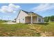 Well-maintained home with lush green lawn, side-entry garage, and covered patio great for outdoor living at 3013 Isle Ln, Monroe, NC 28110