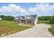 Stunning home with a long driveway and lush green lawn offers ample space and curb appeal at 3013 Isle Ln, Monroe, NC 28110