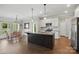 Modern kitchen with granite countertops, stainless steel appliances, and an island, adjacent to dining area at 3013 Isle Ln, Monroe, NC 28110