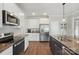 The kitchen showcases stainless steel appliances, granite countertops, and ample cabinet space at 3013 Isle Ln, Monroe, NC 28110