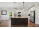 Bright kitchen features stainless steel appliances, granite countertops, and a large island at 3013 Isle Ln, Monroe, NC 28110