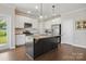 Bright kitchen features stainless steel appliances, granite countertops, and a large island at 3013 Isle Ln, Monroe, NC 28110