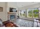 Bright living room featuring a stone fireplace, large windows, and modern decor with stylish flooring at 3013 Isle Ln, Monroe, NC 28110