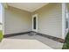 Covered concrete patio featuring neutral siding, an exterior door and ideal for relaxing and entertaining at 3013 Isle Ln, Monroe, NC 28110