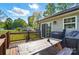 Cozy back deck features a sliding glass door and a picnic table and a grill at 303 Caroline Ave, Lowell, NC 28098