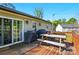 Cozy back deck features a sliding glass door and a picnic table and a grill at 303 Caroline Ave, Lowell, NC 28098