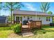 Back deck with wood railing leading to a grassy yard with wood fence and storage shed at 303 Caroline Ave, Lowell, NC 28098