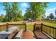 Large, landscaped backyard featuring a wooden deck, firepit, and fenced yard at 303 Caroline Ave, Lowell, NC 28098