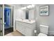 Bathroom with double sink vanity, tiled floor, and framed artwork at 303 Caroline Ave, Lowell, NC 28098