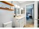Well-lit bathroom with a modern vanity, mirror, and open view of bedroom at 303 Caroline Ave, Lowell, NC 28098