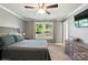 Comfortable bedroom with natural light, a ceiling fan, and neutral decor at 303 Caroline Ave, Lowell, NC 28098